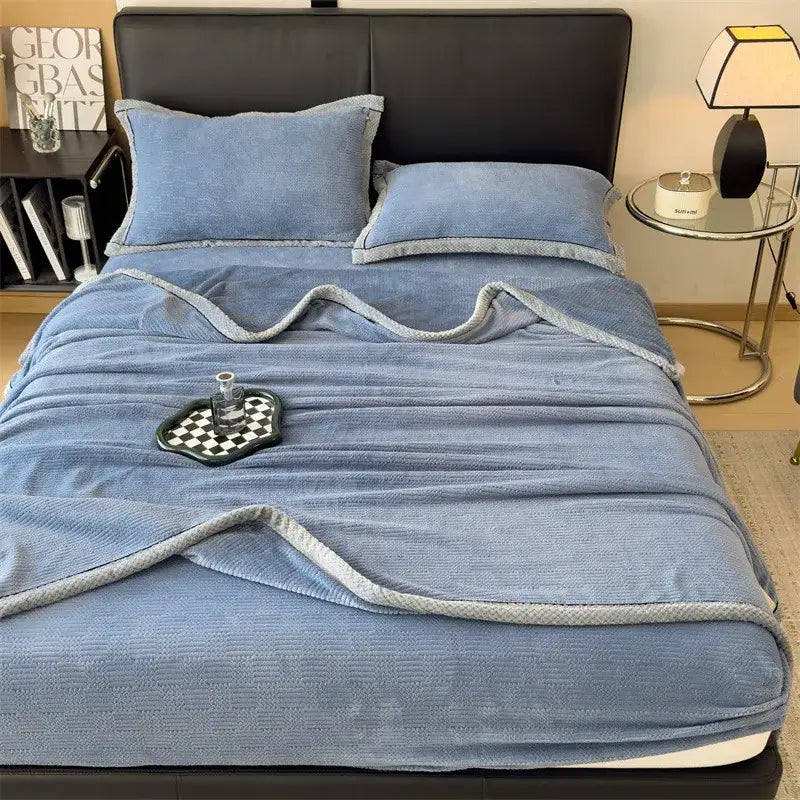 Soft blue velvet blanket with textured weave and light gray braided trim from decorbites carved velvet collection