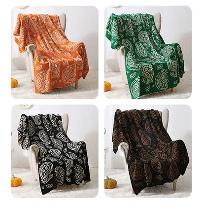 Orange green black and brown paisley-patterned decorbites cashew pattern fleece blankets draped on white armchairs
