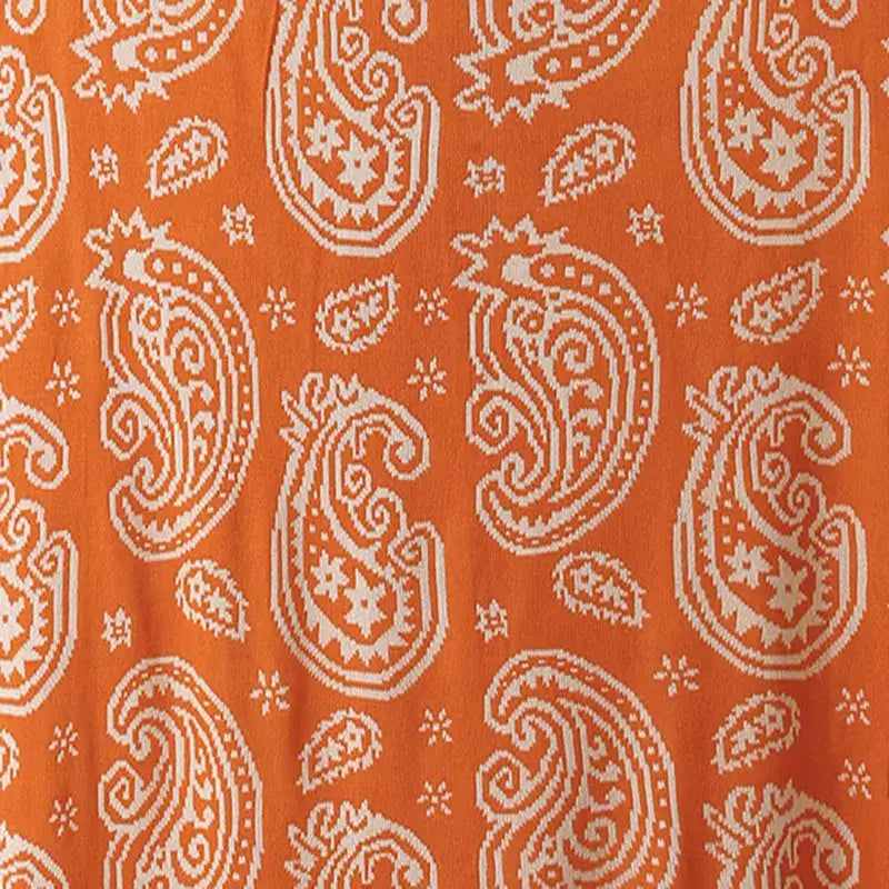 Orange fabric with white paisley decorbites cashew pattern on a living room blanket for cozy decorbites cashew pattern use