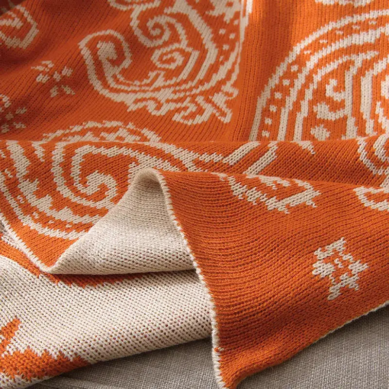 Orange and cream knitted throw blanket with intricate decorbites cashew pattern for living room decor