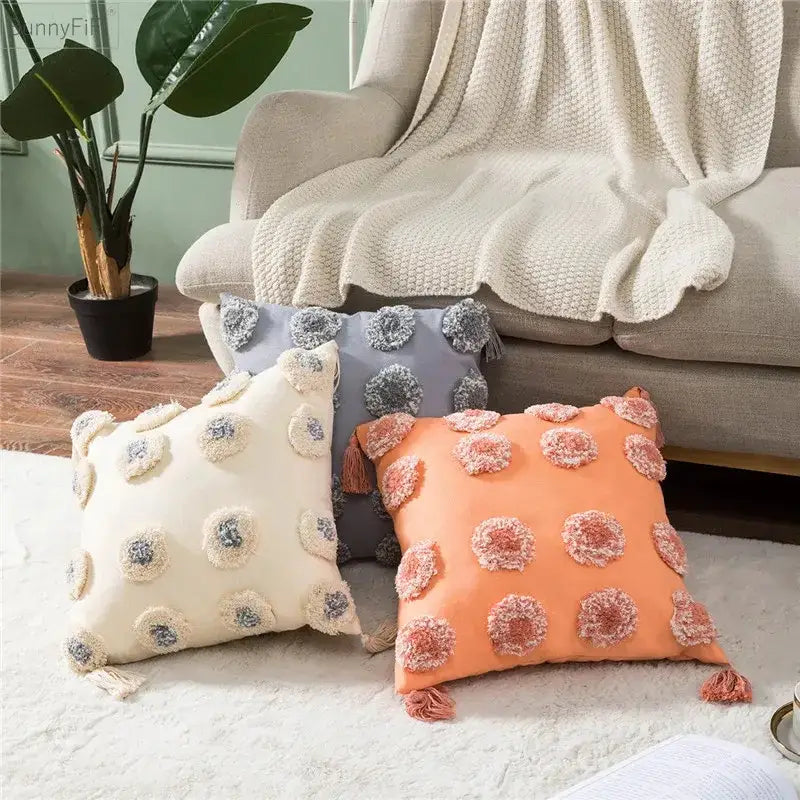 Cream and peach-colored cushion cover with decorbites heart embroidery pom-poms and tassels for living room decor
