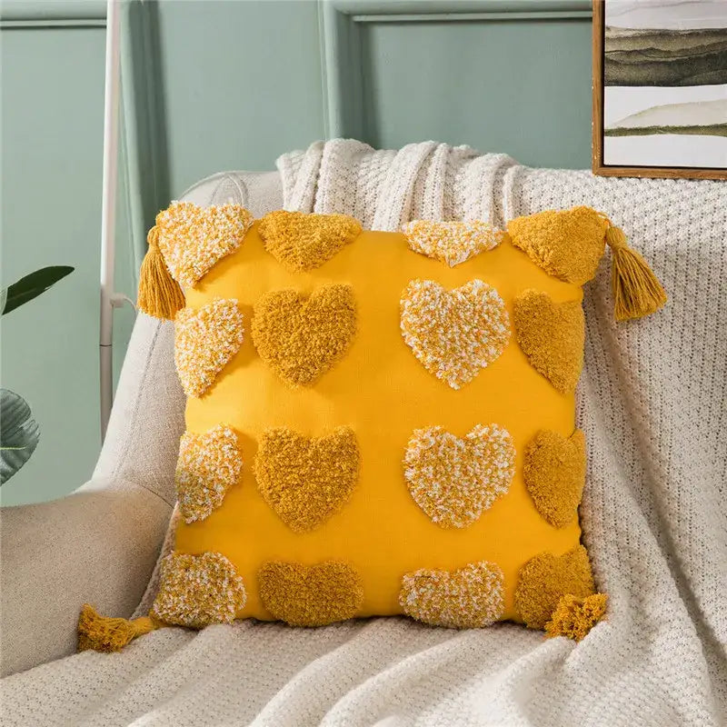 Vibrant yellow cushion cover with decorbites heart embroidery and tassels in orange and grey for living room decor