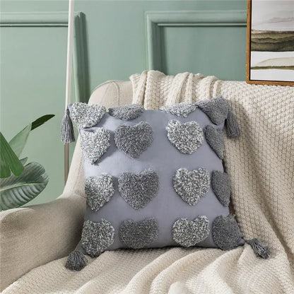 Gray plush cushion cover with decorbites heart embroidery textured pom-poms and matching tassels for living room decor