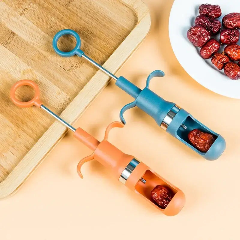 Blue and orange plastic cherry pitter fruit core remover with metal shafts for removing pits from red dates