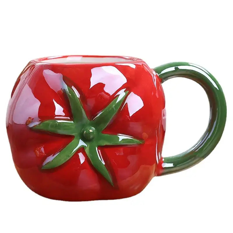 A glossy red ceramic fruit cup shaped like a tomato with green stem and handle from decorbites colorful fruit collection