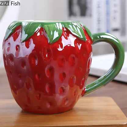 Glossy red strawberry shaped ceramic cup with green leafy handle from decorbites colorful fruit kitchen mug collection