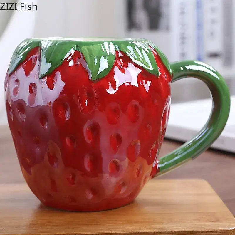 Glossy red strawberry shaped ceramic cup with green leafy handle from decorbites colorful fruit kitchen mug collection