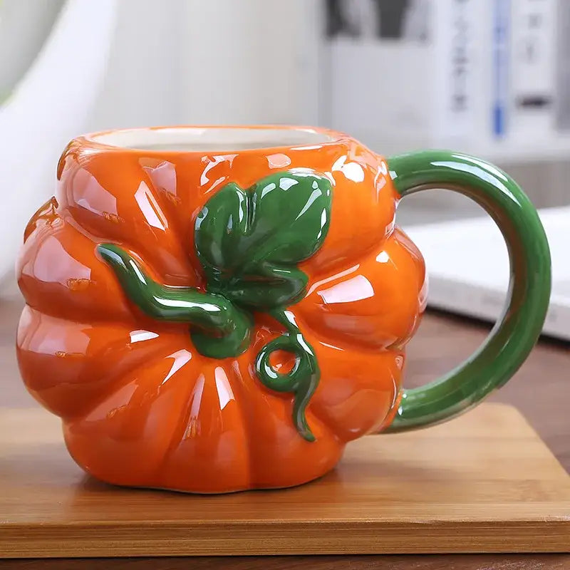 Vibrant orange ceramic pumpkin fruit cup with glossy finish and green stem detail from decorbites colorful fruit collection