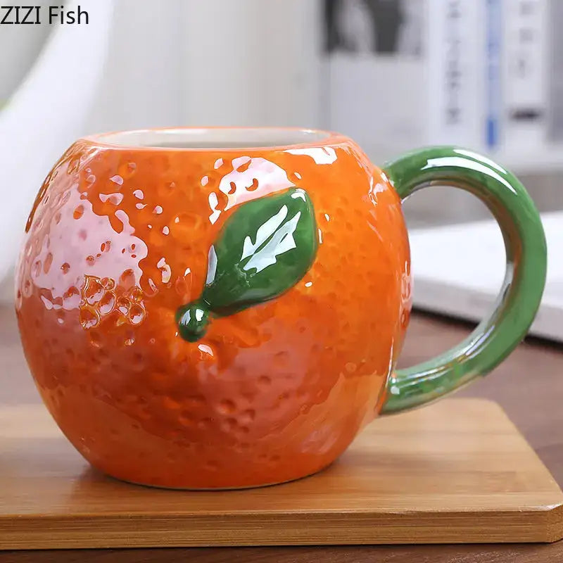 Vibrant orange zizi fish fruit ceramic cup with textured peel and glossy green leaf handle for kitchen breakfast decorbites colorful fruit