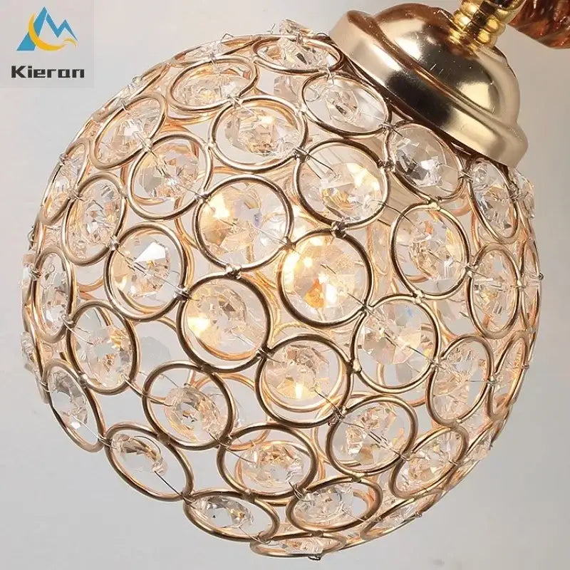 Orange squirrel crystal led wall lamp featuring a gold-toned spherical pendant with clear faceted crystal discs decorbites crystal led