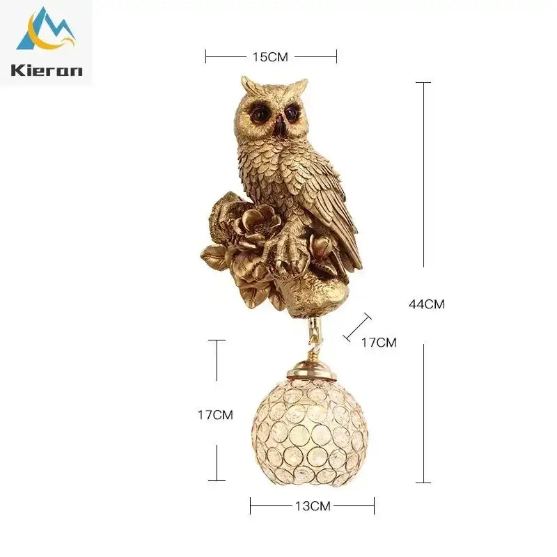 Golden owl figurine with detailed feathers perched on floral design above faceted crystal globe in decorbites crystal led wall lamp