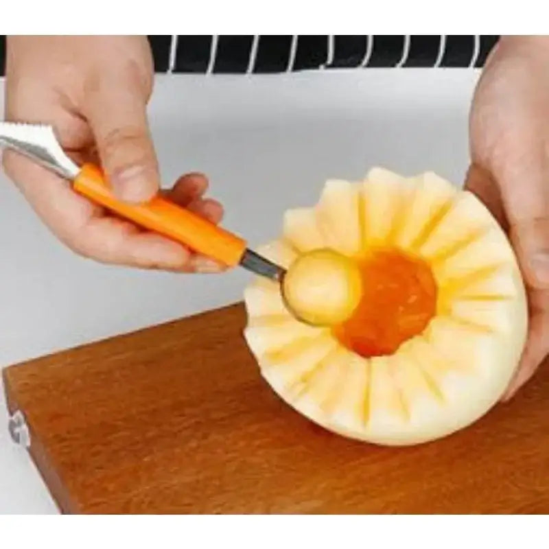 Orange stainless steel mini ball digger kitchen tool with serrated blade and orange handle scooping melon balls