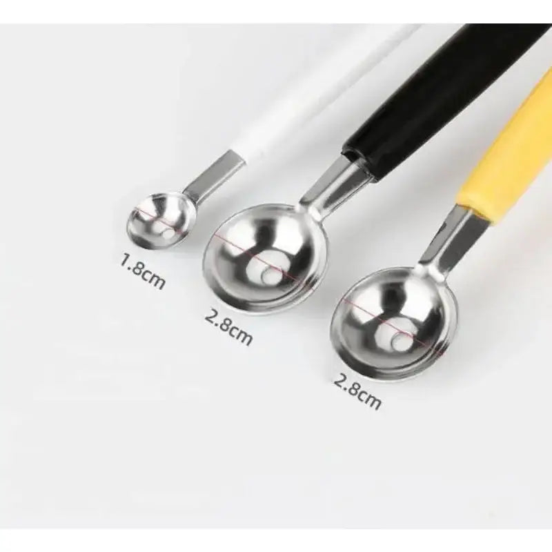Set of three stainless steel mini ball digger kitchen tools with white black and yellow handles for fruit scooping