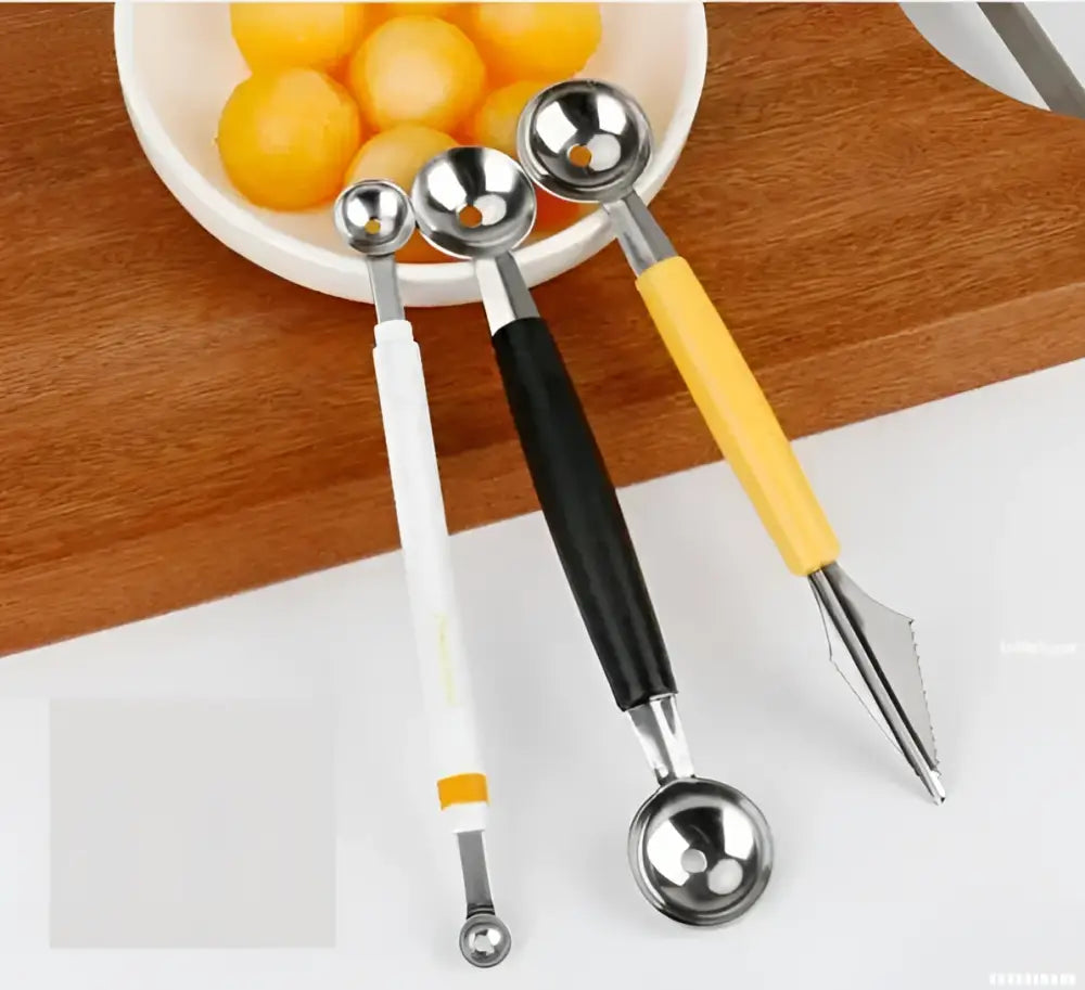 Three stainless steel mini ball digger kitchen tools with handles in white black and yellow for fruit extraction
