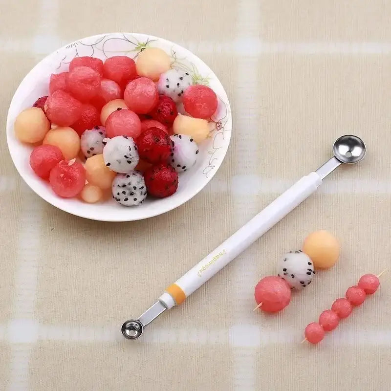 White-handled orange stainless steel mini ball digger kitchen tool with silver metal tips for fruit shaping