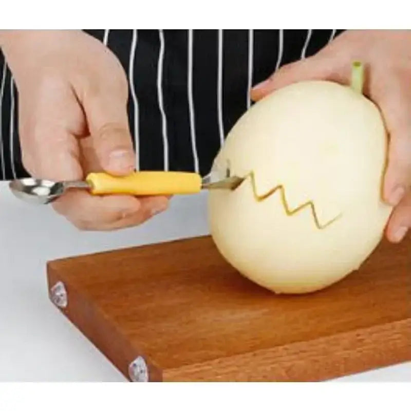 Orange stainless steel mini ball digger kitchen tool with yellow handle, stainless steel spoon head, and serrated blade