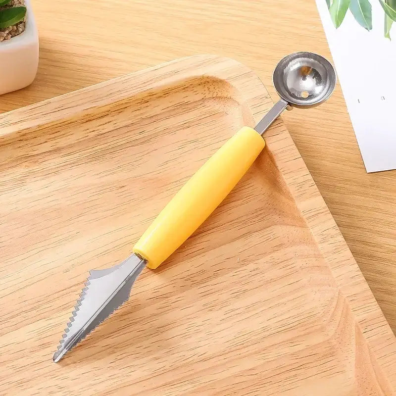 Yellow-handled stainless steel mini ball digger kitchen tool with serrated blade and metallic scoop for fruit coring