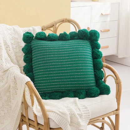 Emerald green woven ball cushion cover with fluffy pom-pom border for living room decor and comfort