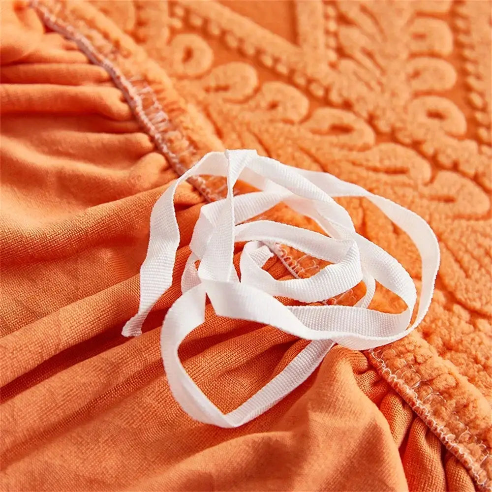 A coiled white grosgrain ribbon on orange jacquard velvet sofa seat covers for living room sofa seat protection