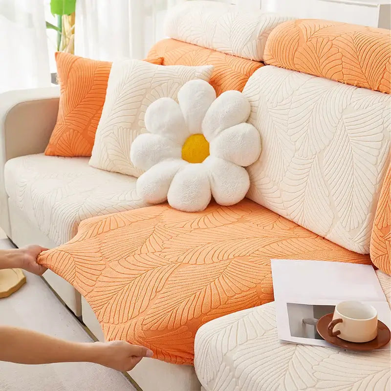 Orange and white leaf jacquard stretch sofa cover with plush white daisy pillow for living room protection