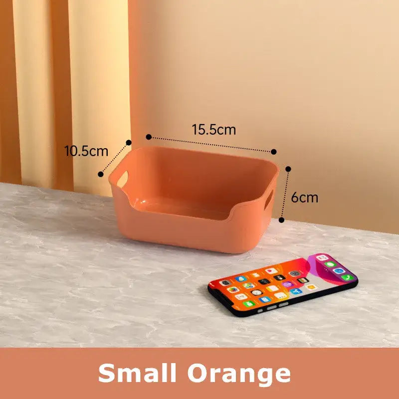 Small orange plastic desktop storage basket with rounded corners and integrated handles for decorbites storage box organizer