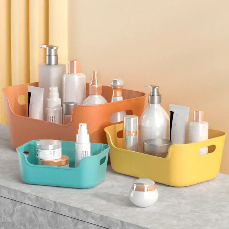 Set of three colorful orange yellow and teal plastic desktop storage baskets for office organization decorbites storage box
