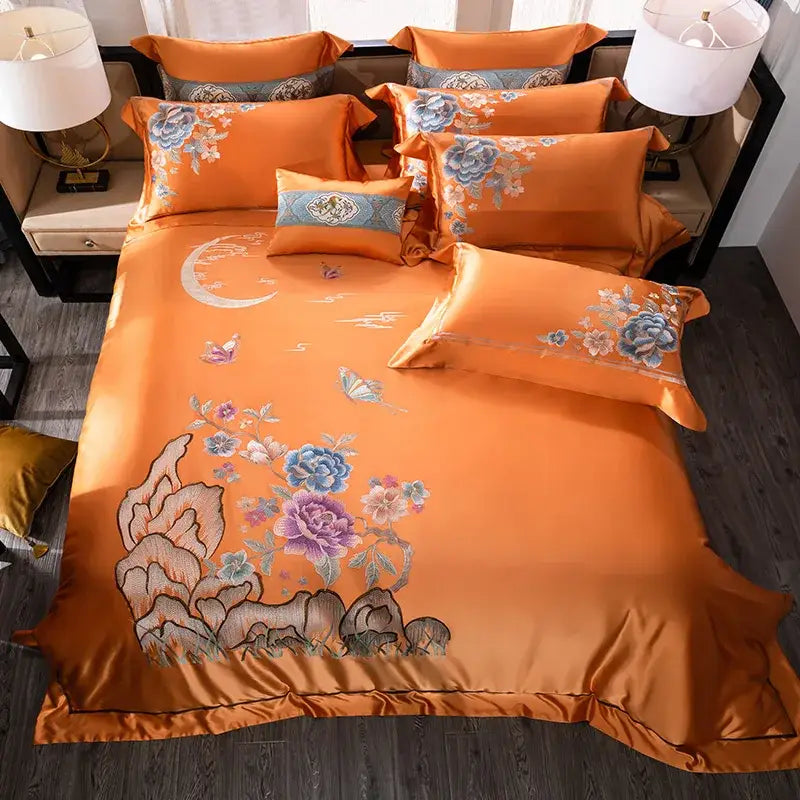 Orchid and blue floral embroidered satin bedding set in vibrant orange made of 200s embroidery egyptian cotton