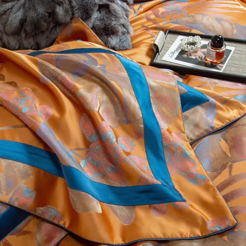 Orchid golden orange and teal egyptian cotton silk bedding set with orchid-patterned satin bedspread and bold teal border stripes
