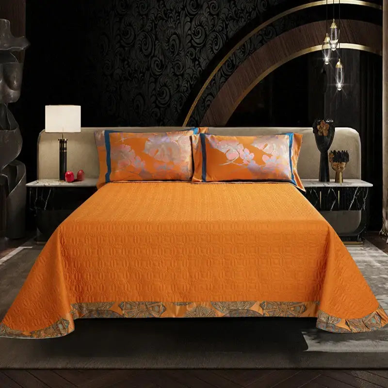 Vibrant orange quilted bedspread with geometric pattern and embroidered border in orchid golden orange egyptian cotton silk bedding set