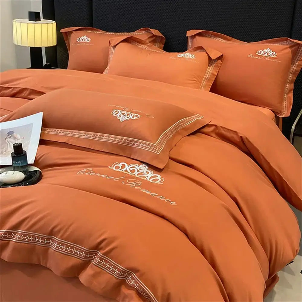 Orange satin bedding set with embroidered eternal romance and crown motifs in white thread 1200tc egyptian cotton