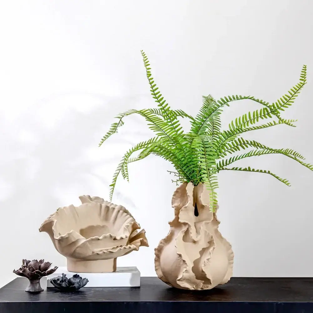 Beige ceramic wavy flower vase with organic ridges holding green ferns for decorbites ceramic wavy living room decor