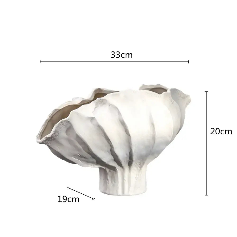 A white ceramic wavy flower vase with fluted leaf-like rim and textured surface for living room decorbites ceramic wavy decor