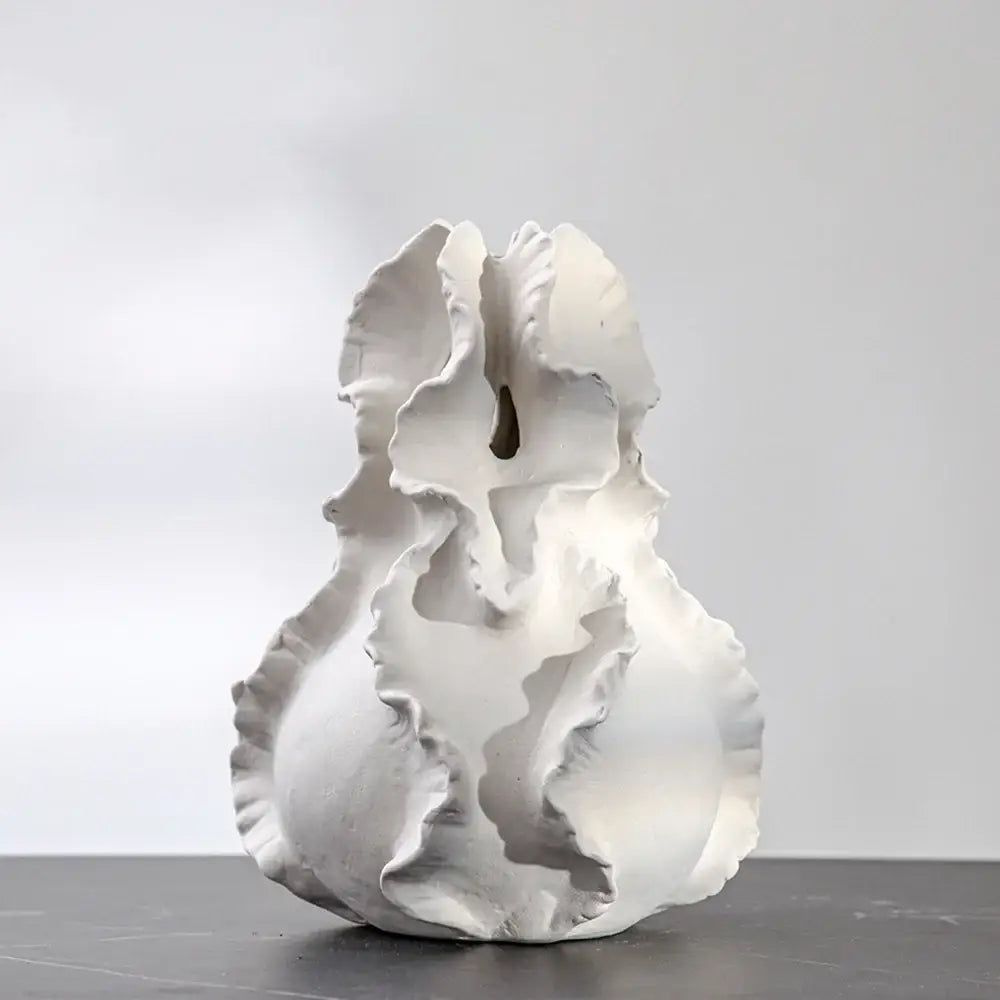 White ceramic sculpture with ruffled organic layers and central opening for decorbites ceramic wavy flower vase storage
