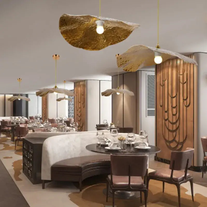 Organic golden iron lotus leaf pendant lights with textured design hang from ceiling for dining room decorbites golden iron