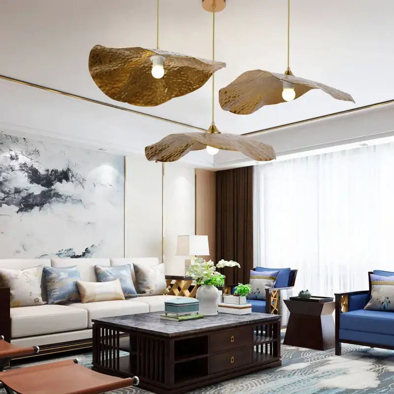 Three golden iron lotus leaf pendant lights hang from ceiling in dining room decorbites golden iron style