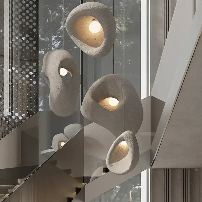 Organic gray textured stone pendant lights with sculptural shapes and warm illumination for dining room decorbites designer led