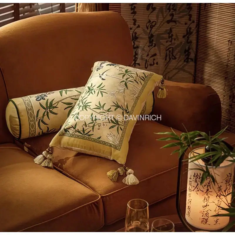 Cream-colored pillow cover featuring intricate green bamboo embroidery and tassels in autum orchid velvet lumbar style