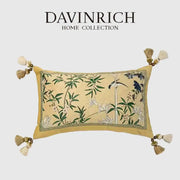 A rectangular beige orchid velvet lumbar pillow cover with embroidered green bamboo leaves and blue birds from davinrich home