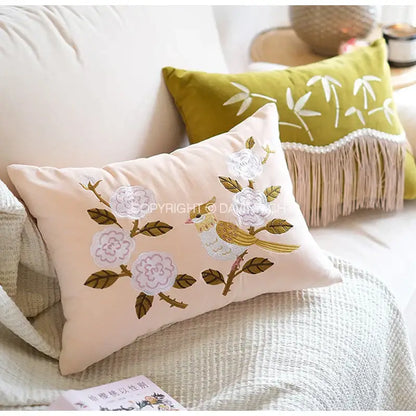 Beige rectangular pillow cover with decorbites bamboo embroidered white flowers green leaves and yellow bird design
