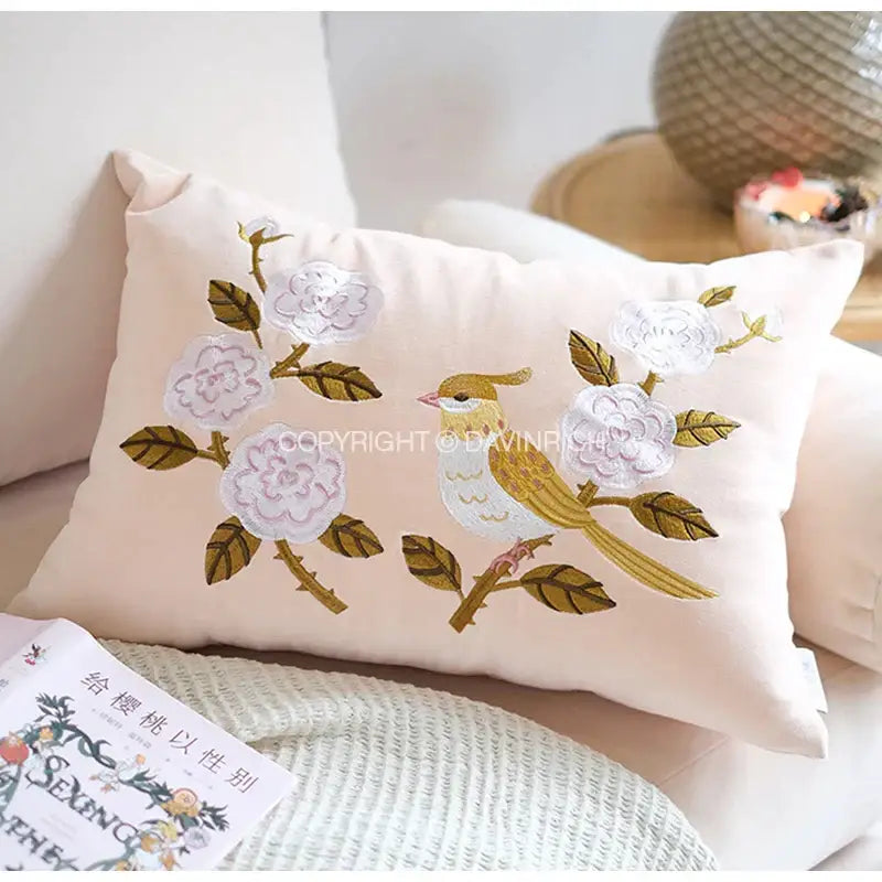 Soft blush pink pillow cover with intricate white flower and golden bird embroidery for decorbites bamboo embroidered fringe
