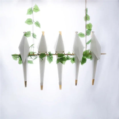 White origami bird design led pendant light with gold accents and green leafy vines for dining room decorbites bird design