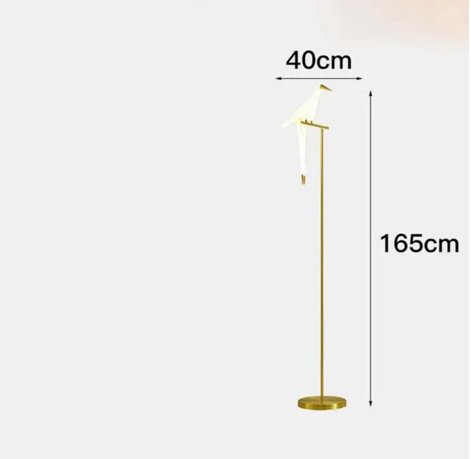 A sleek gold-toned floor lamp with a minimalist bird design led featuring an elegant white bird for decorbites bird design