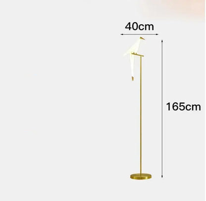 A sleek gold-toned floor lamp with a minimalist bird design led featuring an elegant white bird for decorbites bird design