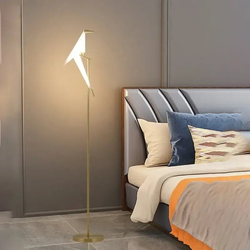 Gold-toned origami crane floor lamp with sleek minimalist design and warm ambient lighting by decorbites bird led floor lamp