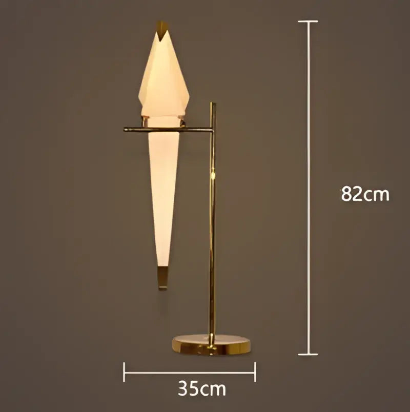 Gold-toned table lamp with sleek frosted glass shade and minimalist metal frame complements decorbites crane chandelier iron