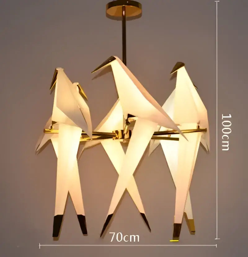 A modern decorbites crane chandelier with gold-toned iron frame white paper wings and black-tipped feet led light for bedroom