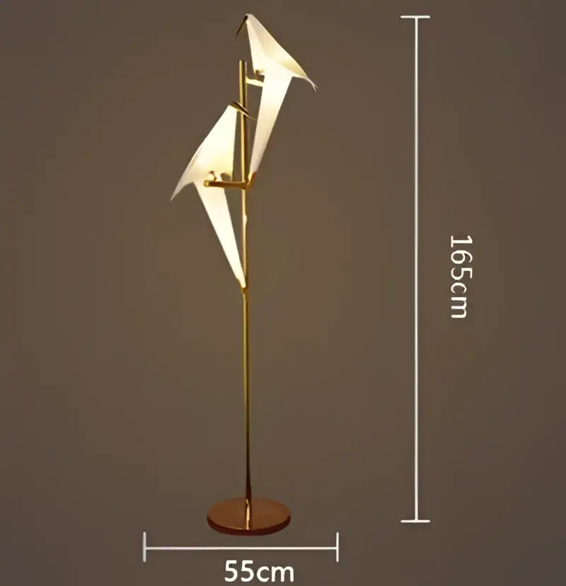 Gold-toned floor lamp with two white origami crane-shaped light fixtures in a decorbites crane chandelier iron led design