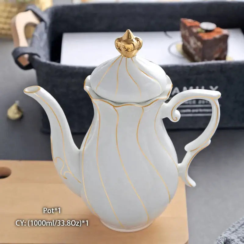 Ornate white porcelain tea pot with gold trim and golden crown lid from decorbites bone china collection
