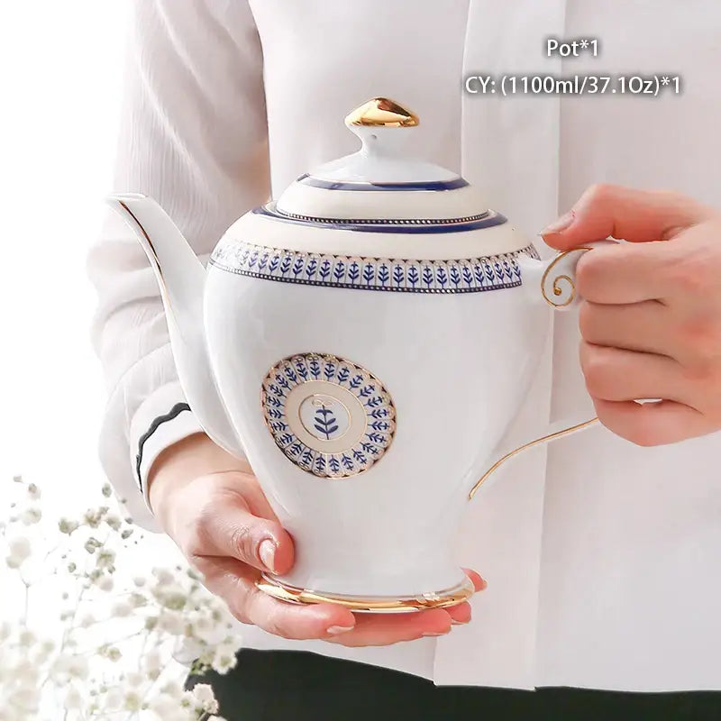Ornate 18th century bone china tea pot with blue floral patterns gold trim and decorative circular motif decorbites bone china