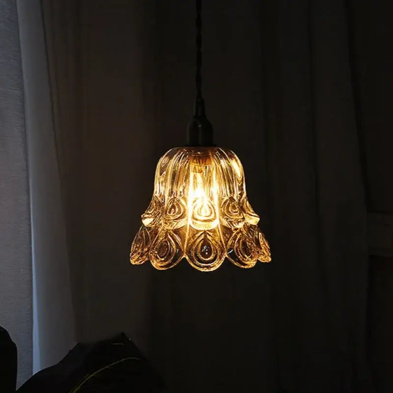 Ornate warm-toned amber copper led pendant light with peacock feather detailing and dark metal chain for café décor